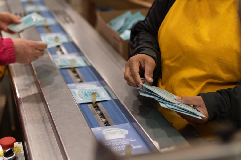 Promotional literature cards and a sample running through a flow wrap machine