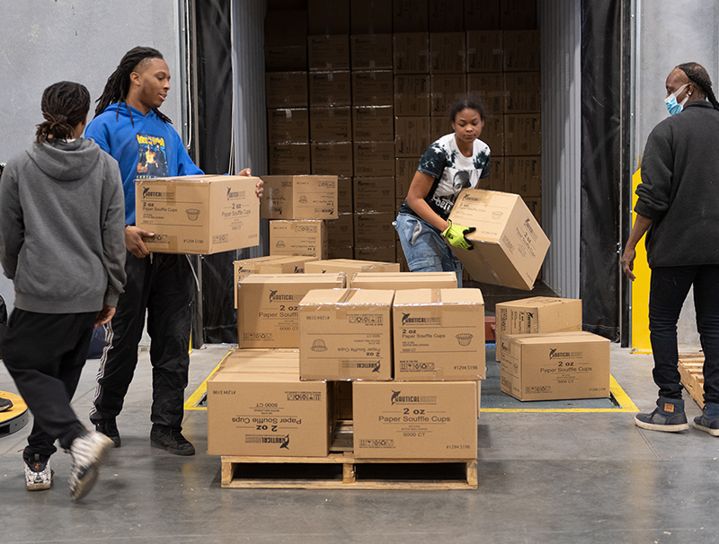 Warehouse staff filling up a box truck for delivery